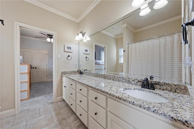 full bath featuring double vanity, crown molding, and a sink