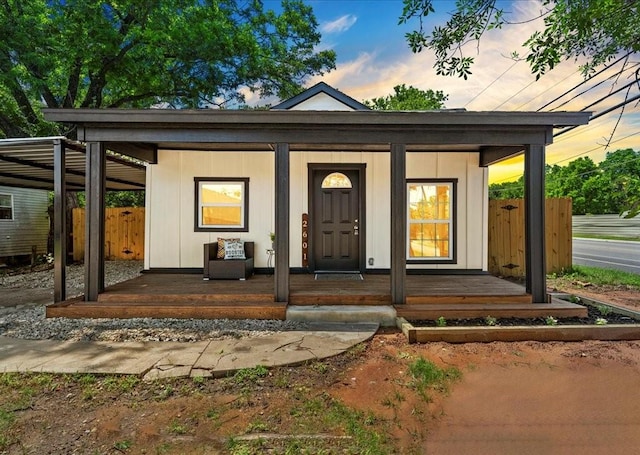 exterior entry at dusk featuring covered porch