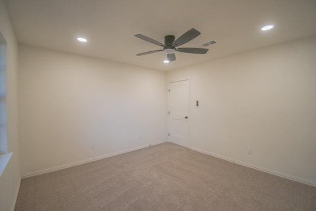 spare room featuring carpet floors and ceiling fan