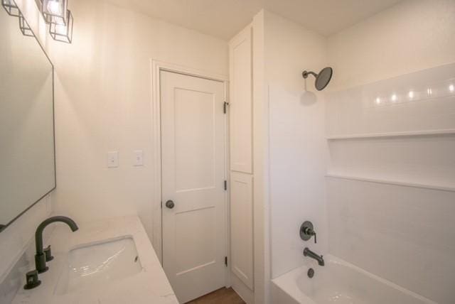 bathroom with vanity and shower / washtub combination