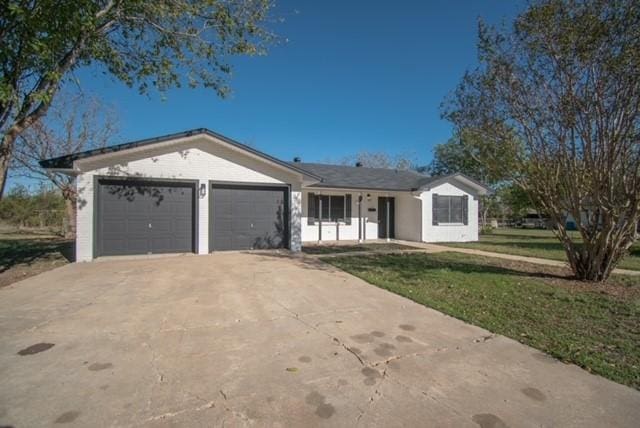 single story home with a front yard and a garage