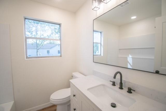 bathroom featuring vanity and toilet