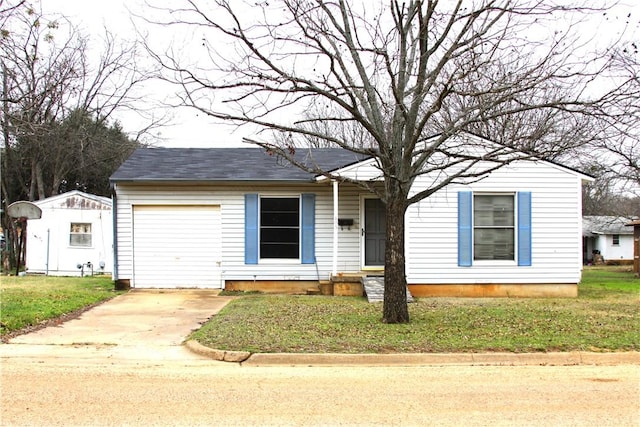 view of front of home with a front lawn, entry steps, driveway, and an attached garage