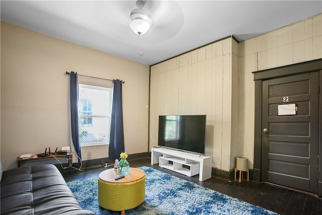 living room featuring dark hardwood / wood-style flooring and ceiling fan