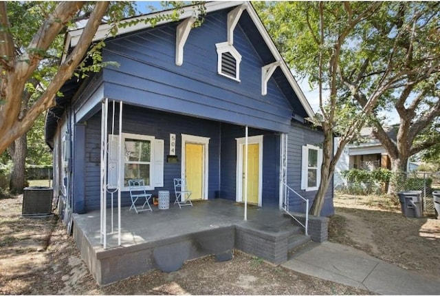 view of front facade featuring covered porch and central air condition unit