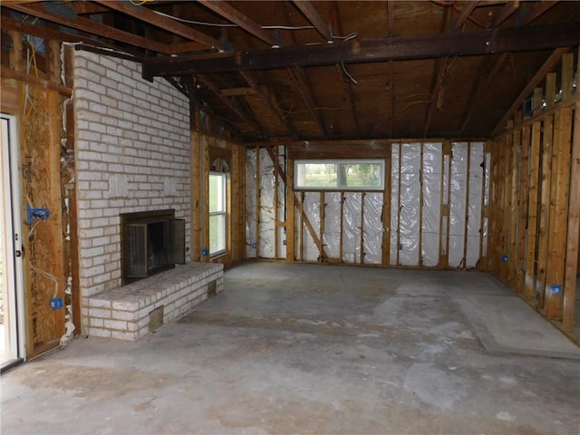 unfurnished living room featuring a brick fireplace