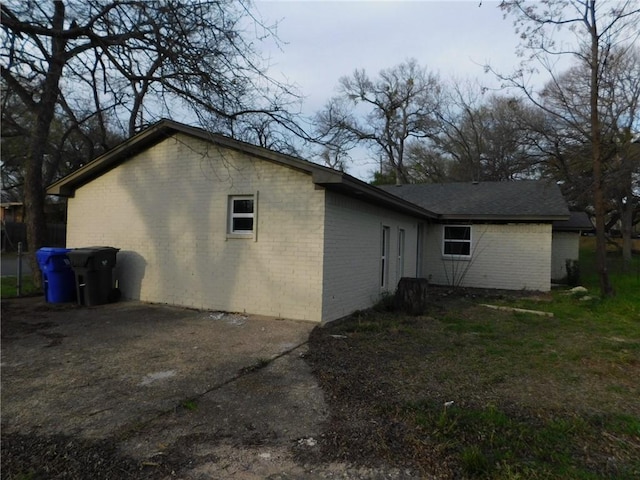 view of side of property featuring brick siding