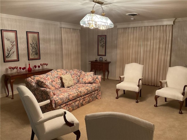 living room with ornamental molding, light carpet, and a chandelier