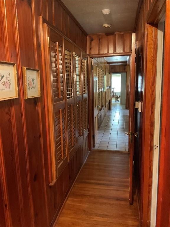 hallway featuring wood walls and light hardwood / wood-style floors