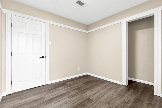 unfurnished bedroom featuring dark hardwood / wood-style floors