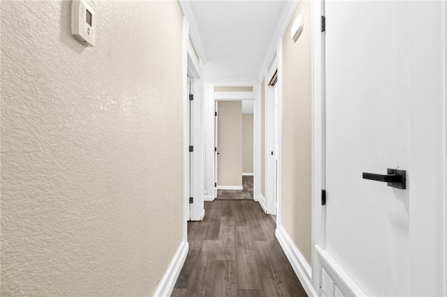 hallway with dark hardwood / wood-style flooring