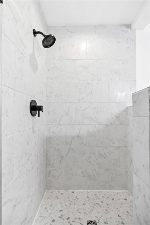 bathroom with a tile shower