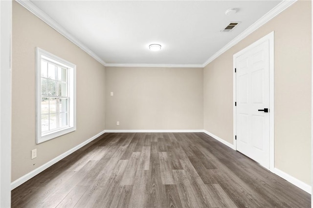 spare room with dark hardwood / wood-style flooring and crown molding