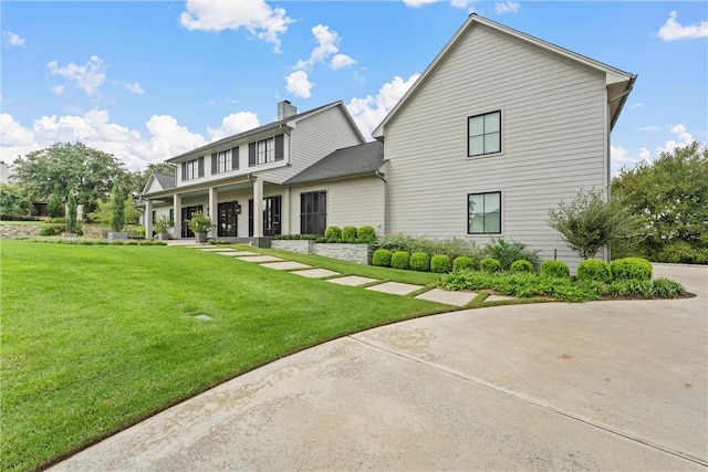 back of property featuring a lawn