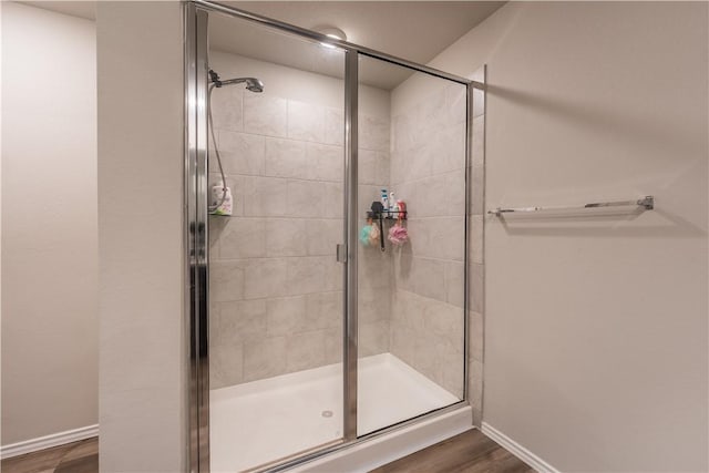 bathroom featuring wood-type flooring and walk in shower