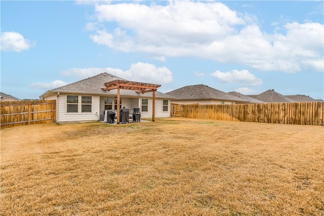 back of property featuring a pergola and a lawn