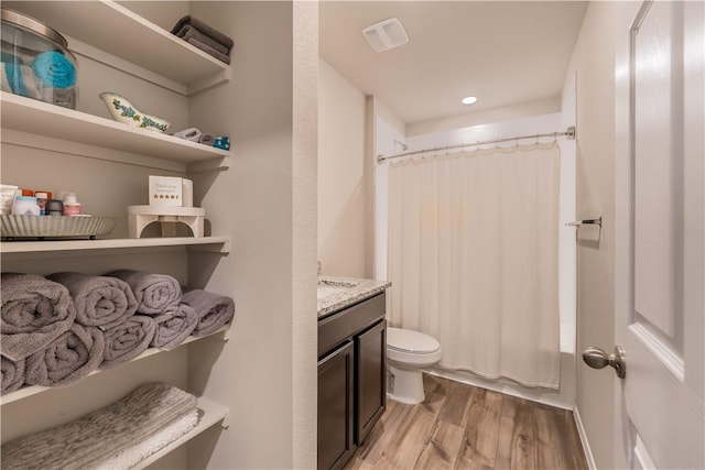 full bathroom with shower / bath combination with curtain, vanity, toilet, and hardwood / wood-style floors