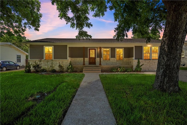 view of front facade featuring a lawn and a porch