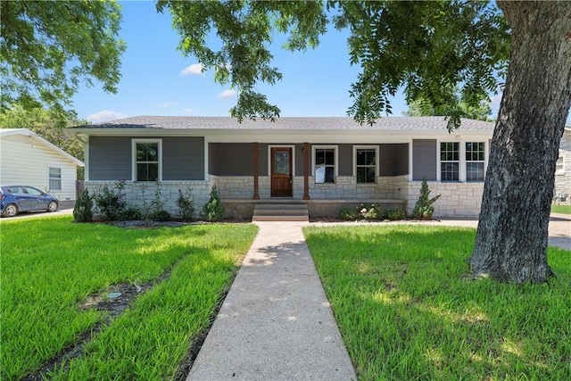 single story home with covered porch and a front yard