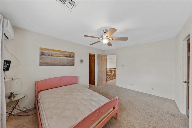 bedroom with a wall mounted AC, carpet floors, and ceiling fan