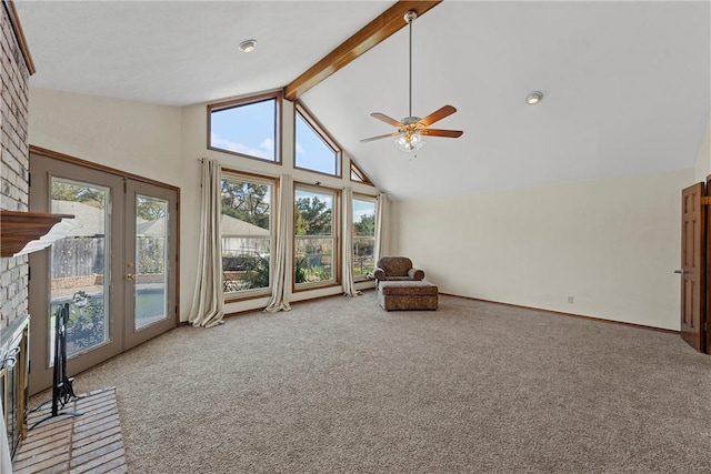 sitting room featuring high vaulted ceiling, carpet floors, and a wealth of natural light