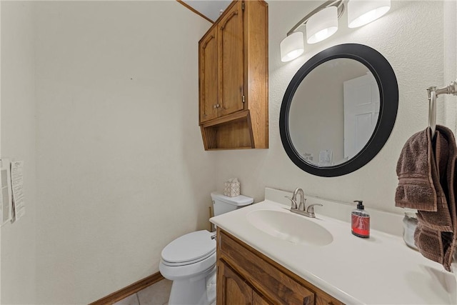 bathroom featuring tile patterned floors, vanity, and toilet