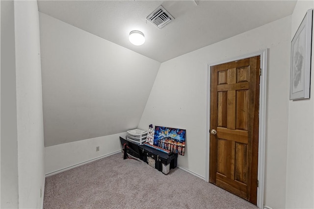 miscellaneous room with light carpet and vaulted ceiling