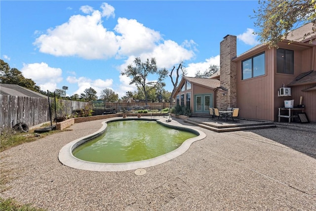 view of pool with a patio area and french doors