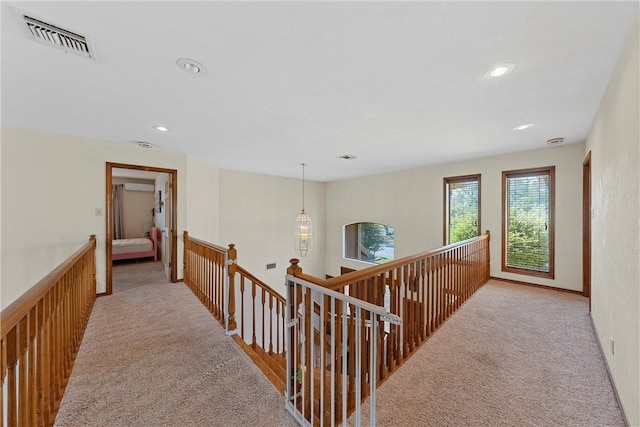 hallway featuring light colored carpet