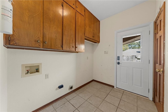 laundry room featuring hookup for an electric dryer, light tile patterned flooring, cabinets, and hookup for a washing machine