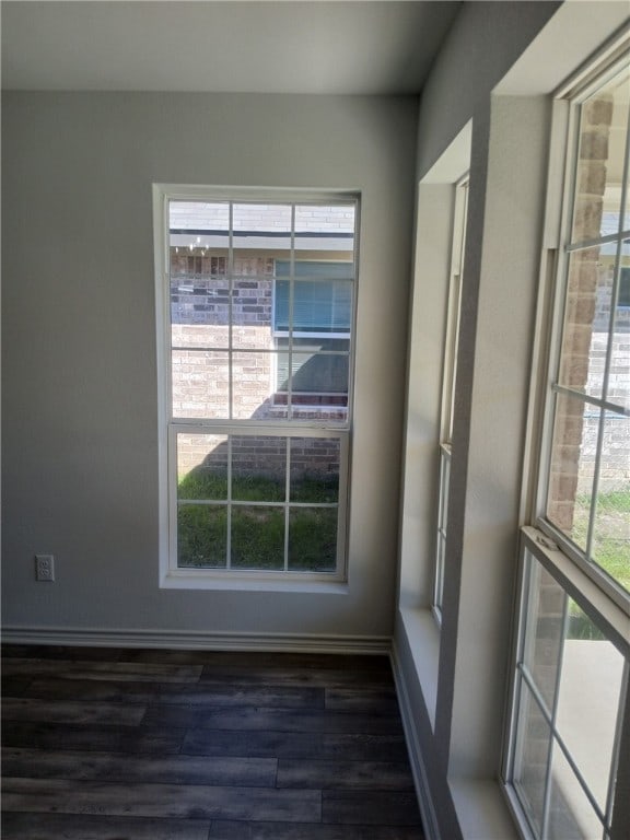 unfurnished room with dark hardwood / wood-style floors