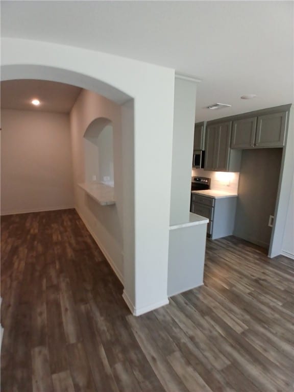 corridor with dark hardwood / wood-style floors