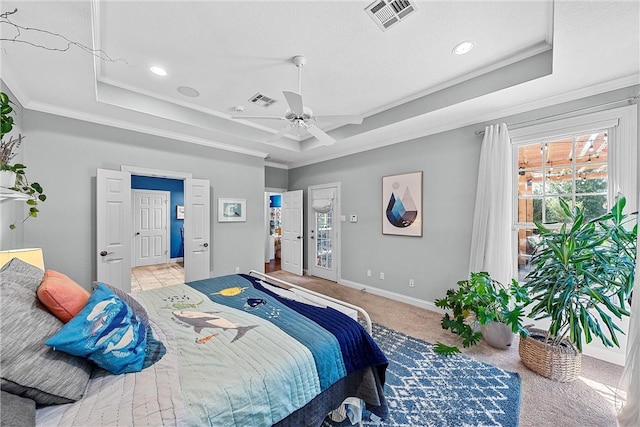 carpeted bedroom with a raised ceiling, ceiling fan, and crown molding