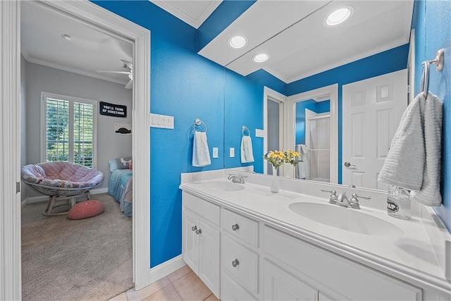 bathroom featuring tile patterned floors, ceiling fan, vanity, and ornamental molding