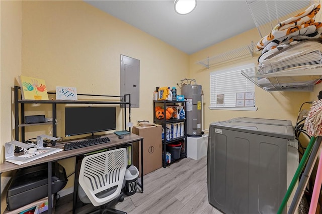 office area with electric water heater, washer / clothes dryer, light hardwood / wood-style flooring, and electric panel