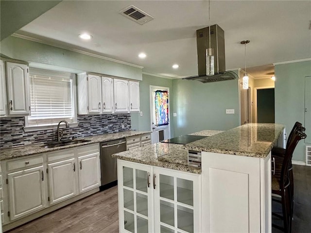 kitchen with stainless steel dishwasher, a kitchen island, pendant lighting, island exhaust hood, and white cabinets