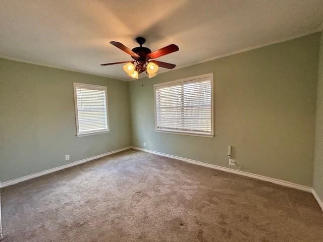 carpeted empty room with crown molding and ceiling fan