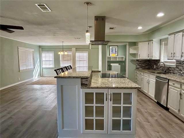 kitchen with sink, stainless steel dishwasher, a center island, and white cabinets