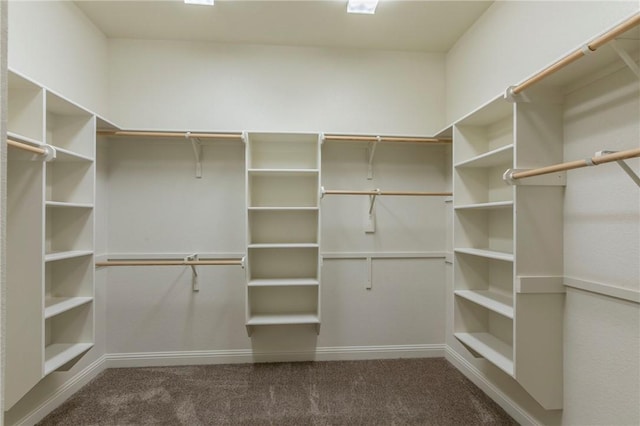 spacious closet featuring dark carpet