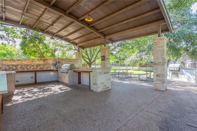 view of patio with area for grilling and exterior kitchen