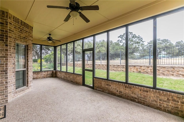 unfurnished sunroom with ceiling fan and a healthy amount of sunlight