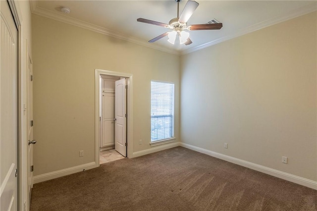 unfurnished bedroom with ceiling fan, crown molding, light carpet, and a closet