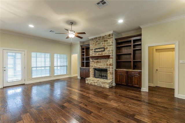 unfurnished living room featuring dark hardwood / wood-style flooring, a stone fireplace, and ornamental molding