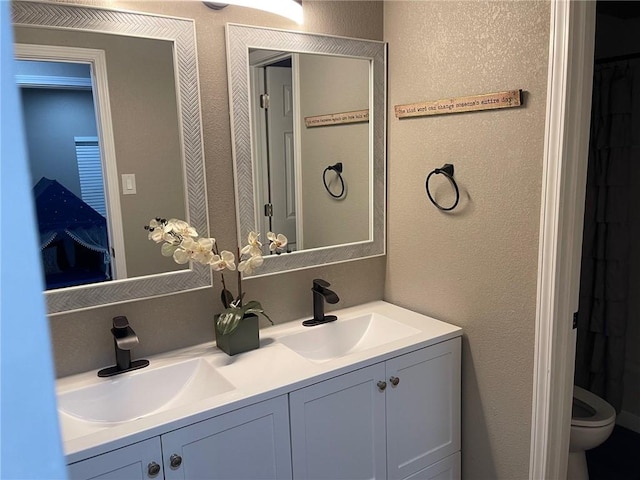 bathroom with vanity and toilet