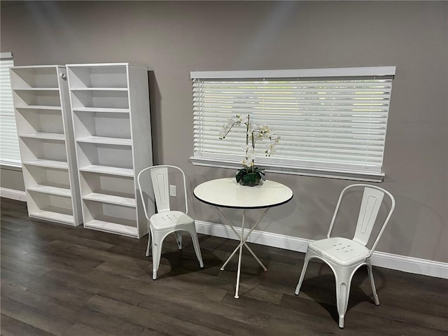 dining space featuring a wealth of natural light and dark hardwood / wood-style flooring