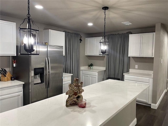 kitchen featuring white cabinetry, stainless steel fridge with ice dispenser, dark hardwood / wood-style floors, and decorative light fixtures