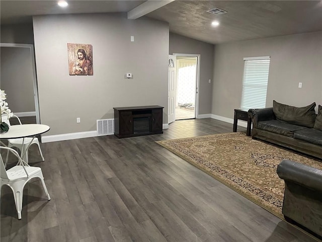 living room with dark hardwood / wood-style flooring and vaulted ceiling with beams