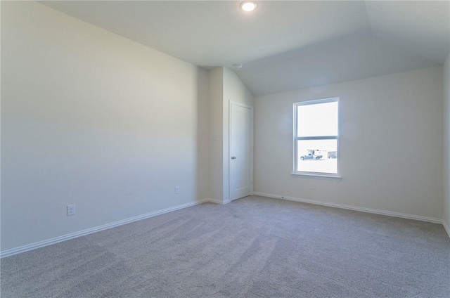 empty room with vaulted ceiling, recessed lighting, carpet, and baseboards