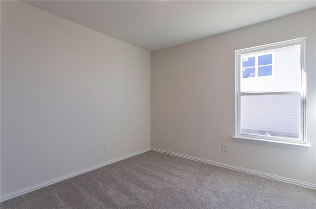 empty room with light carpet and baseboards