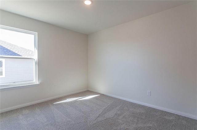 carpeted empty room featuring baseboards and recessed lighting